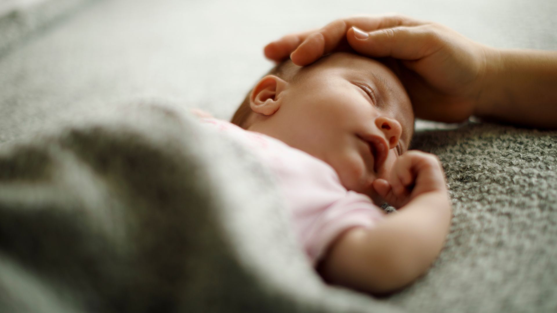 A close up of a person holding a baby